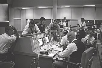 Э. Си (стоит в центре) в Центре управления полетами в Хьюстоне во время полета «Джемини-5» (21 августа 1965)