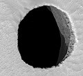 Полученное HiRISE изображение показывает освещённую восточную стену пещеры Жанна.