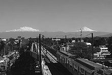 A picture of Line 12’s overground track with a train passing by.