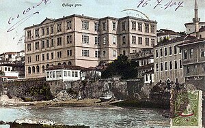 Photograph of a multi-story limestone structure built into a cliff.