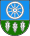 A coat of arms depicting a white wheel on a light blue background at the top and three white leaves on a green background at the bottom