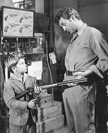Black and white promotional image of Tommy Rettig and Robert Mitchum in the 1954 film River of No Return