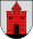 A coat of arms depicting a red castle with black double doors, two black windows, and one central tower all standing on black ground