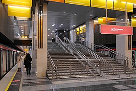 Огороженная лестница будущего перехода на одноимённую станцию Троицкой линии и колонны, вид под углом