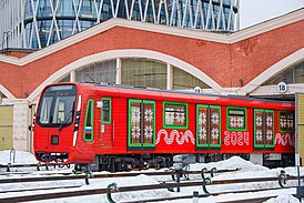 Вязаный новогодний поезд 2024 в красном оформлении на выезде из депо