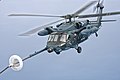 Японский противолодочный вертолет UH-60J осуществляет дозаправку в воздухе с самолета-танкера MC-130P 353-й группы спецопераций над Японским морем. 5 июня 2014