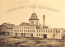 A black and white image of a factory with a steeple, a smokestack, and the caption «C. Feigenspan’s lager beer brewery.»